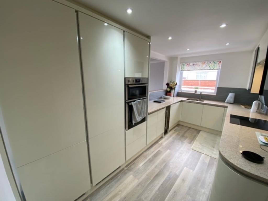 Kitchen Makeover with Brown Tones and Wood Flooring